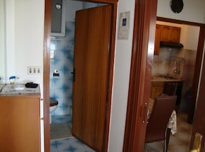 A compact kitchen with a sink, stove, and cabinets. - One Bedroom Apartment with Terrace and Sea View (Petrcane)