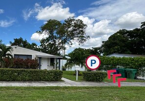 A residential area with a no parking sign, a white house, and a fence. - Private studio by Miami International Airport (Miami)