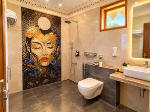 A bathroom with a mosaic wall, a shower, a toilet, a sink, and a mirror. - The Desert Mafia Resort & Camp (Jaisalmer)