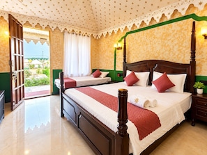 A hotel room with a four-poster bed, a second bed, a balcony, and a view of the surrounding area. - The Desert Mafia Resort & Camp (Jaisalmer)