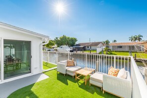 A residential property with a patio area featuring outdoor furniture and a view of a body of water. - Brand new!! Water front home in serene Dania Beach. Located near airport. (Dania Beach)