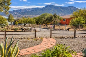 A paved pathway leading to a fenced area with cacti and a mountain backdrop. - Clarkdale Suite Mingus Mountain Verde Valley Views (Clarkdale)