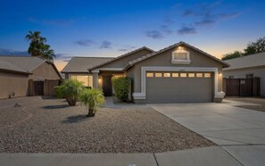 A warm Arizona sunset greets you at the front of the home. - Casa Clara Retreat | Private Pool & Hot Tub (Surprise)