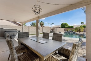 Gather around the outdoor table with a little fireside warmth. - Casa Clara Retreat | Private Pool & Hot Tub (Surprise)