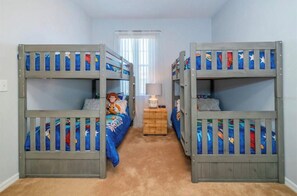 A room with bunk beds, a lamp, and a window. - LUXURY ORLANDO VACATION HOME PRIVATE HEATED POOL SLEEPS 11 NEAR DISNEY&UNIVERSAL (Davenport)