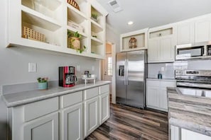 The fully equipped kitchen includes stainless steel appliances, a coffee station, and plenty of storage, making it easy to cook, gather, and feel at home. - Sweet Home | 2BR Cottage w/ Hot Tub & Fire Pit (Broken Bow)