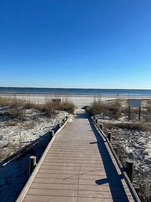A wooden boardwalk leading to a beach with a clear sky. - Seascape Hideaway - Steps to Beach - Suite (Hilton Head Island)
