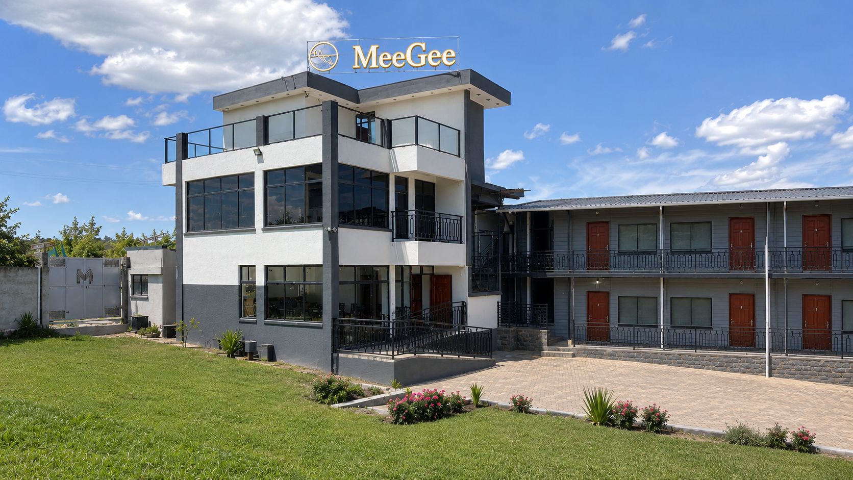 Un bâtiment moderne à deux étages, doté d’un toit plat, de grandes fenêtres et d’un logo bien visible.