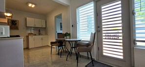 A compact kitchen with a dining area, a refrigerator, and a microwave. - Private 2BD/2BA Rear Casita in Guaynabo (Guaynabo)