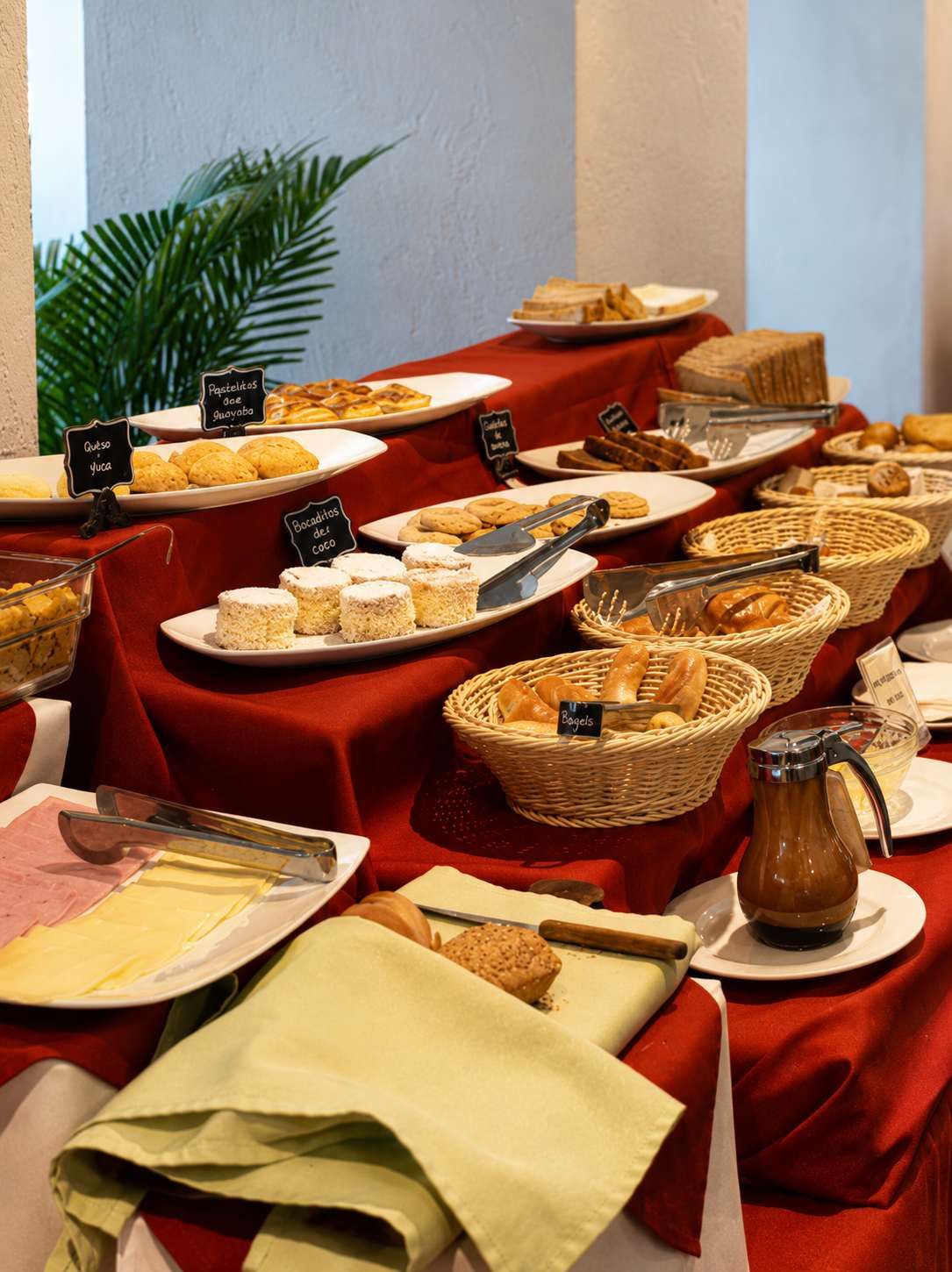 A buffet table with various food items and labels.