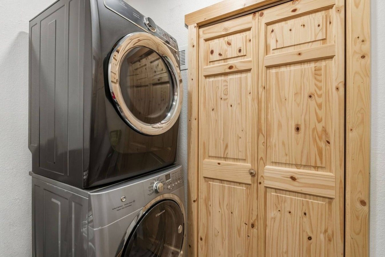 Convenient laundry area with a stacked washer and dryer