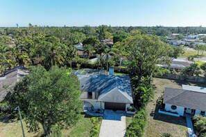 A residential area with houses, a large water tower, and dense greenery. - Private Pool, Pickleball, Mini Golf, Game Room, Near AMI (Bradenton)