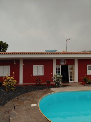 A building with a swimming pool, red walls, and a tiled roof. - Little Climbers 1 (El Paso)