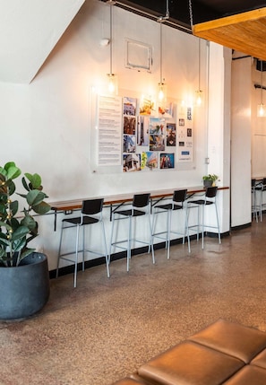 A reception area with a bulletin board, seating, and a potted plant. - Apartments, 2 Bedrooms, Near Old San Juan-16 (San Juan)