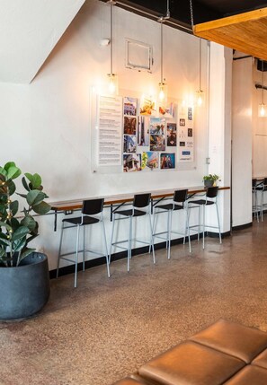 A reception area with a bulletin board, seating, and a potted plant. - Apt with Balcony Near Old San Juan-8 (San Juan)