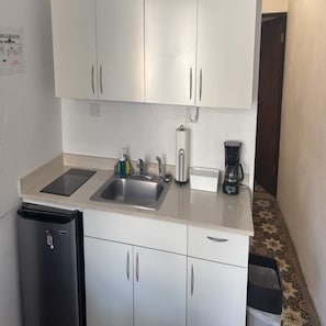 A compact kitchen with a sink, a coffee maker, and a refrigerator. - Apt with Terrace near Beaches & Old San Juan-15 (San Juan)