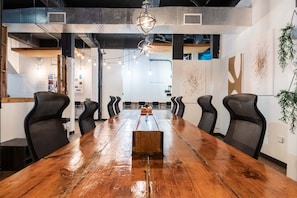 A conference room with a long wooden table, black chairs, and a whiteboard. - Penthouse with Terrace, Near Old San Juan and Condado-10 (San Juan)