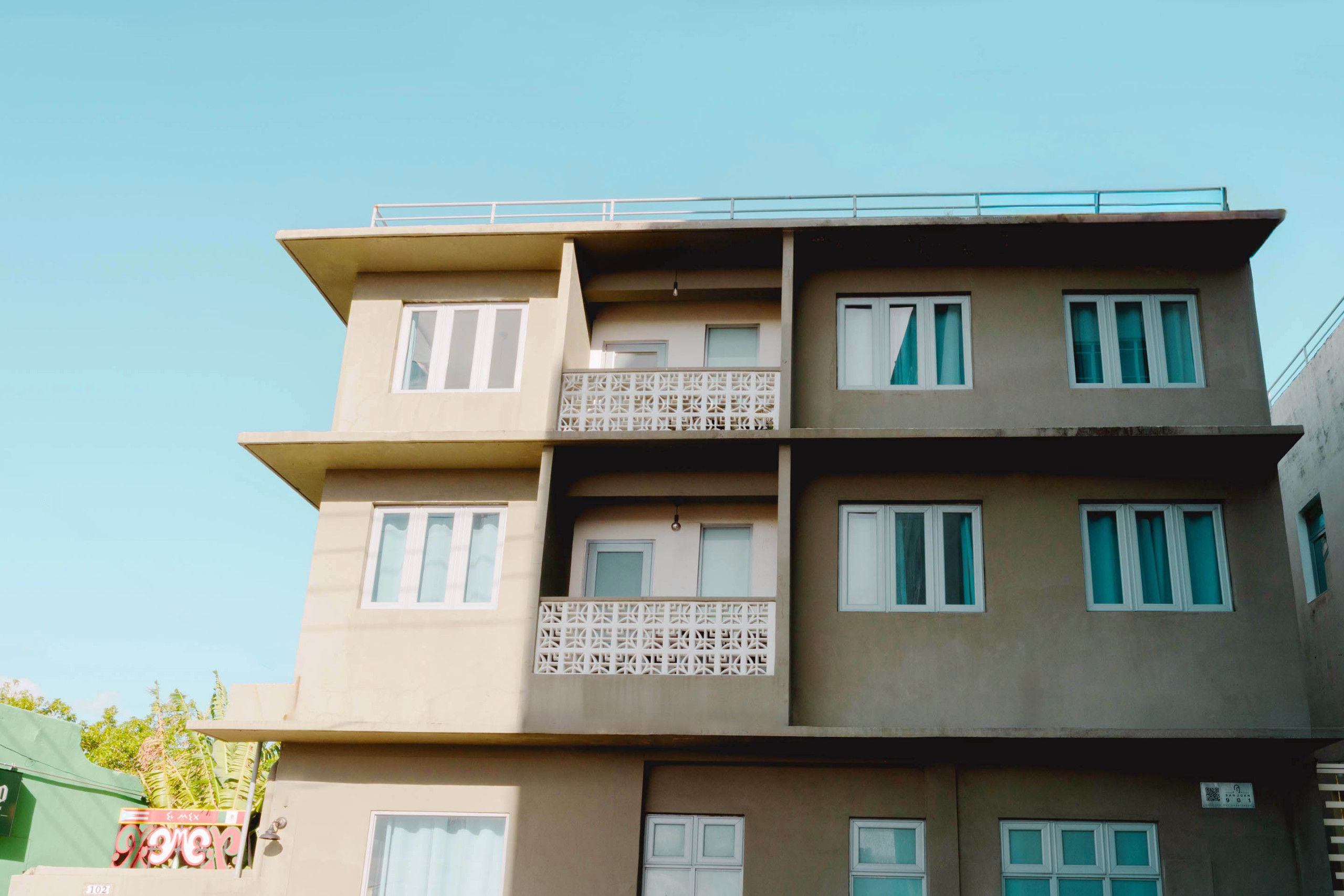 A multi-story building with balconies and windows.