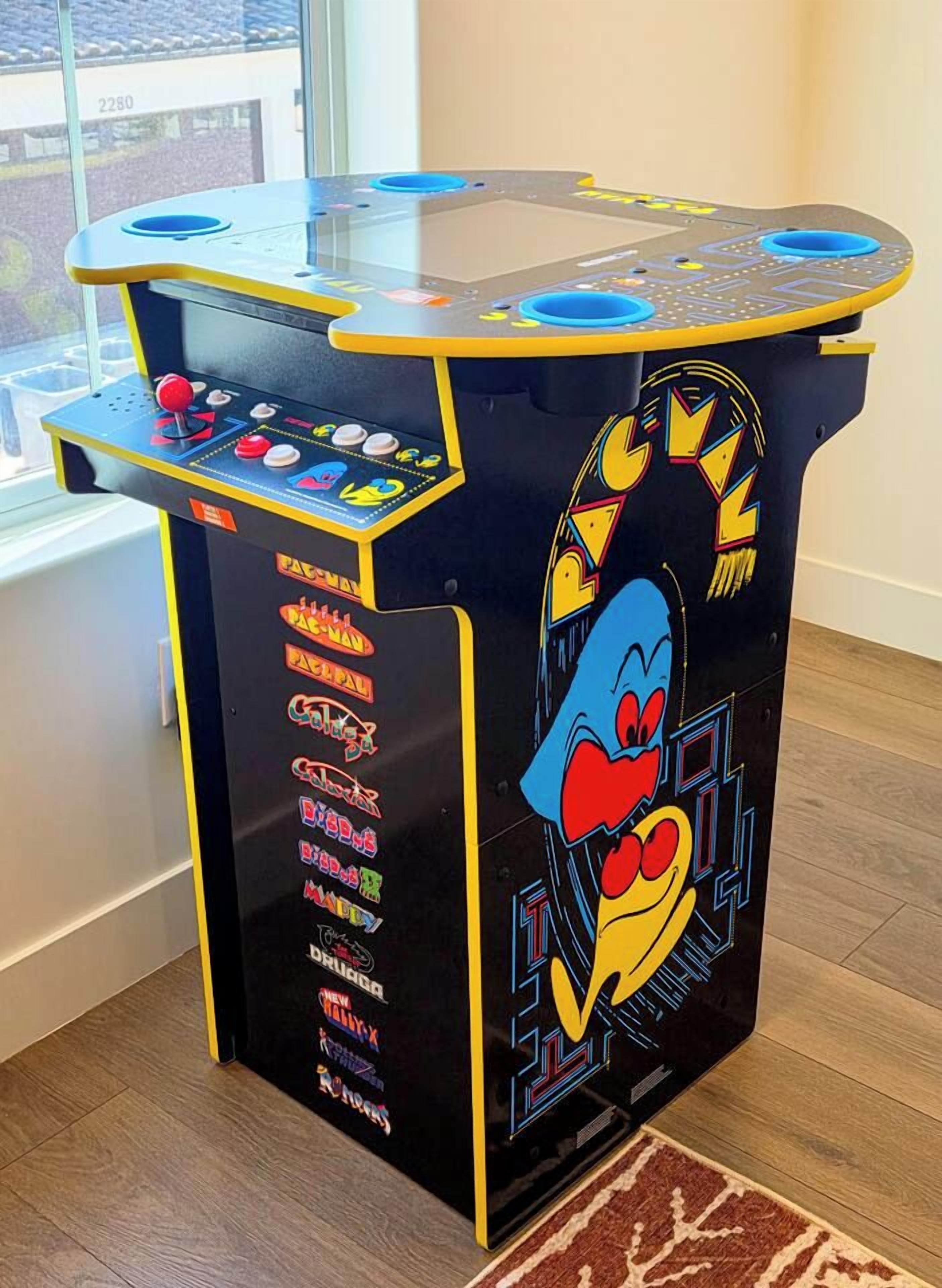 A retro arcade machine with a joystick and buttons, featuring a cartoon character and various game titles.