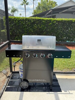Ein Charbroil Grill mit vier Drehreglern, einer digitalen Anzeige und einem Wasserbehälter.