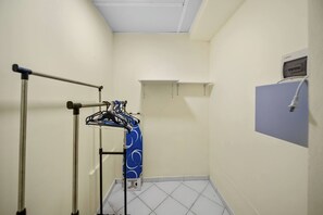 A bathroom with a towel rack, a shelf, and a wall-mounted device. - Cheap Hotel Room in Sosua Strip! (Sosúa)