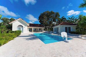 A two-story house with a swimming pool, surrounded by lush greenery and palm trees. - Hispaniola Villa No26 Near Sosua Beach (Sosúa)