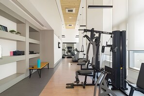A gym with exercise equipment, wooden floors, and white walls. - Prime Studios Centro Osasco15min Alpha (Osasco)