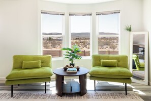 A room with two green armchairs, a round table, and a potted plant. - Beyond Horizon, Private Casita, Stargazing & Fast WiFi (Joshua Tree)