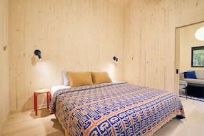 A room with a bed, a small stool, and a sofa. - Scandi Spruce Cabin in the Woods #2 (Grand Rapids)