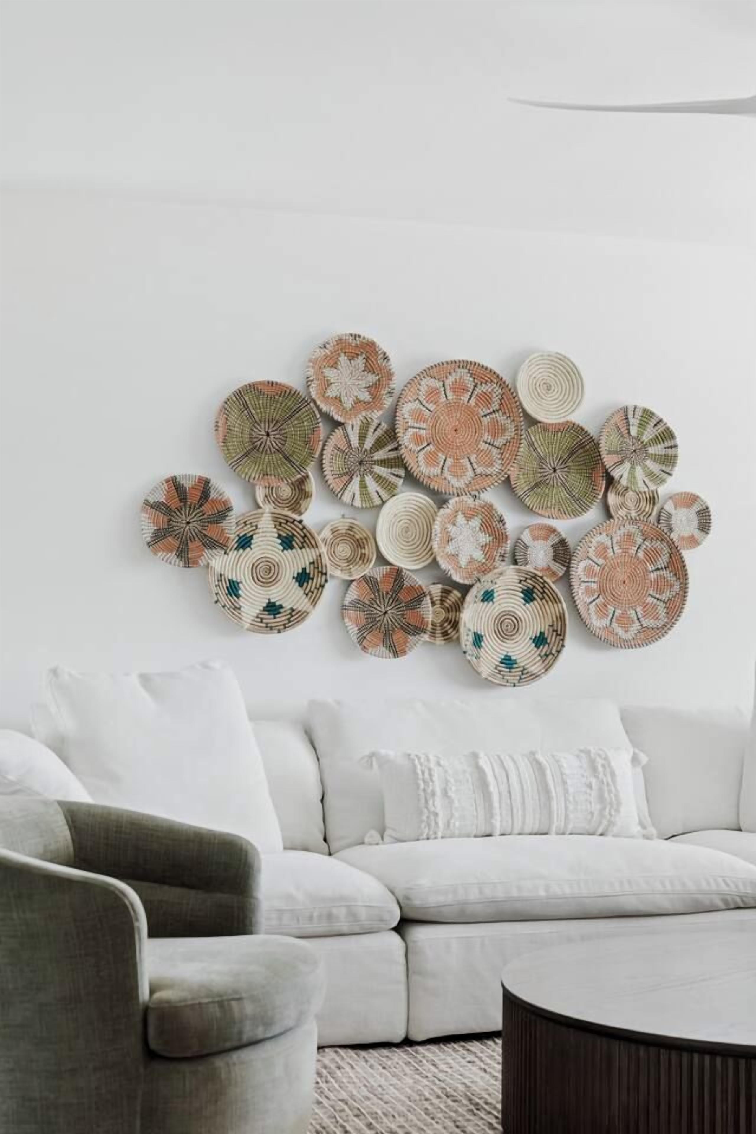 A living room with a white sofa, a grey armchair, and a round coffee table.