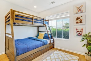 A bunk bed with a wooden frame, blue bedding, and a window with blinds. - Pool, Spa & Games  4BR Near Indio Polo Grounds (Indio)