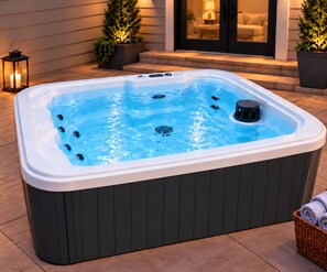 A hot tub with jets, surrounded by outdoor furniture and potted plants. - Lakefront Paradise 4 king bedrooms, Hot Tub & Private Beach ,fire pit sleeps 12 (Little Elm)