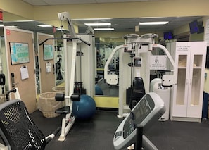 A gym with exercise equipment, a mirror, and a sign for a spa. - Oceanfront 2 Bedroom Unit for 6 people at Palm Beach Shores Resort Singer Island (Palm Beach Shores)