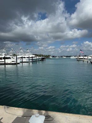 A marina with multiple boats docked, calm water, and a partly cloudy sky. - Oceanfront 2 Bedroom Unit for 6 people at Palm Beach Shores Resort Singer Island (Palm Beach Shores)