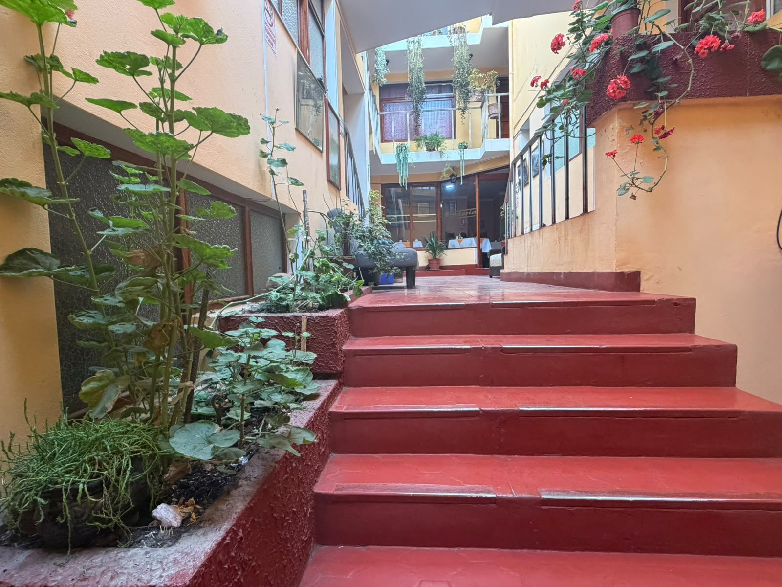 A multi-level building with red steps leading to a balcony area.