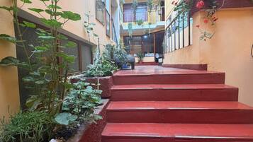 A multi-level building with red steps leading to a balcony area.