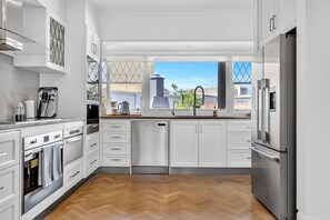 Stainless appliances and leadlight window over the sink. - The Regatta House | 4BR, 3.5 Bath, Waterfront (West Lakes)