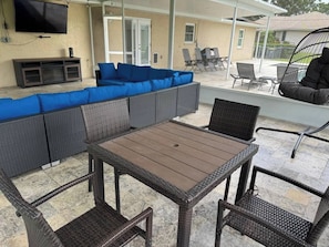 An outdoor patio with a sectional sofa, a table, and chairs. - 4 Bedroom Cul-de-Sac Pool Home w/ Gameroom (Lakeland)