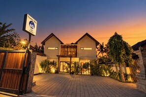 A hotel with a two-story structure, a gated entrance, and a signboard. - 3-Bedroom Beach Front Villa with Ocean View in Tulamben Karangasem Bali (Karangasem)