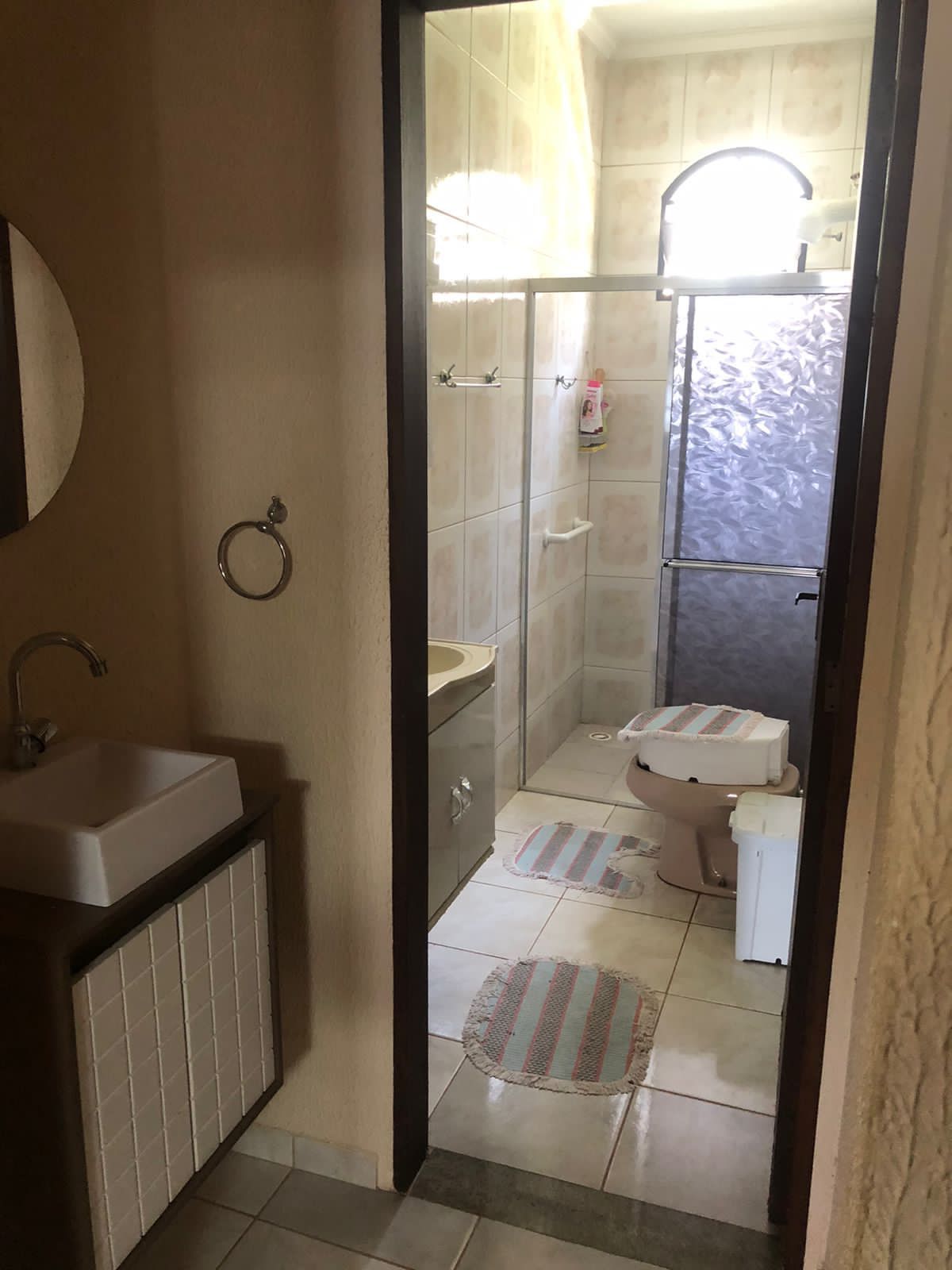 A bathroom with a sink, toilet, and shower area.