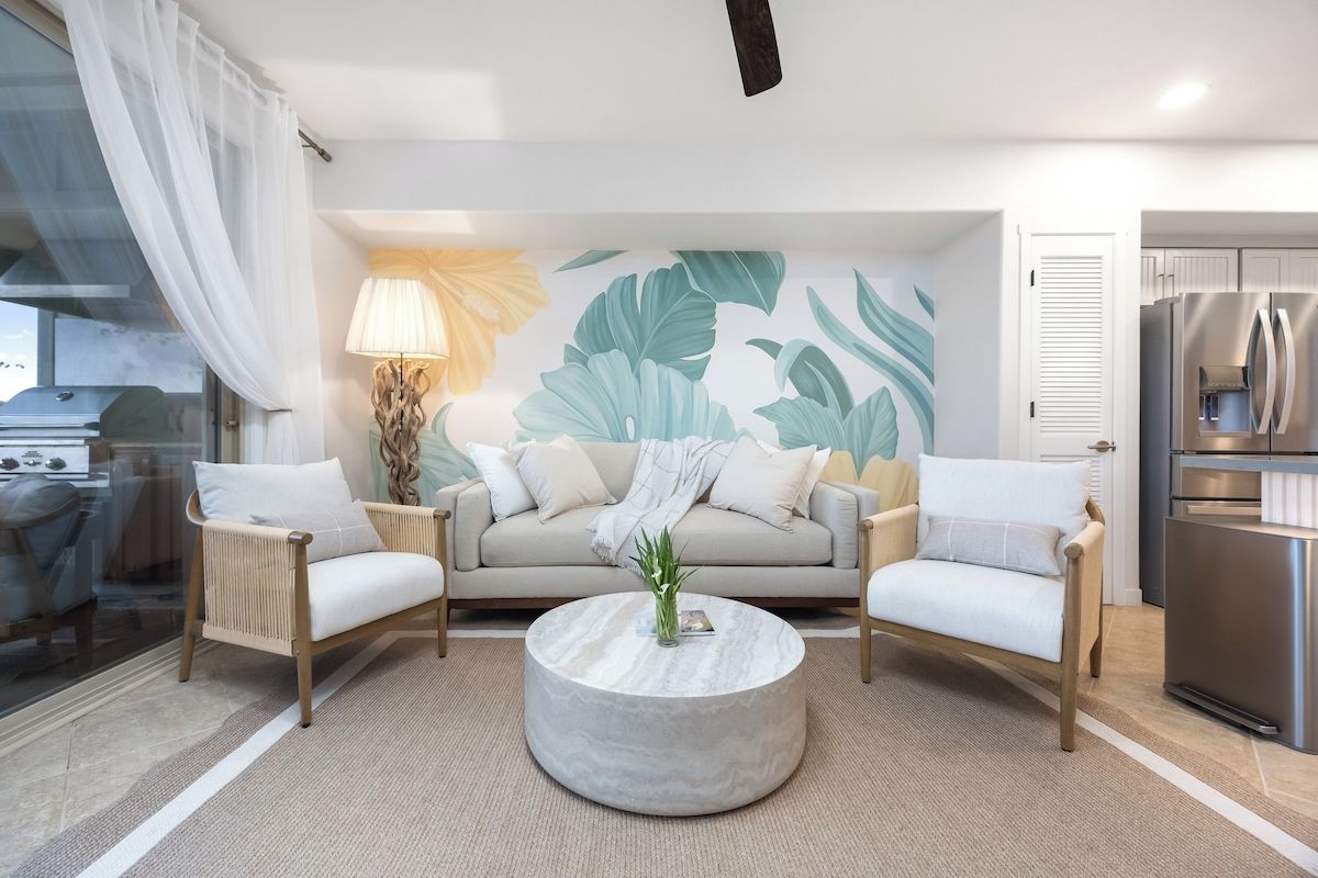 A modern living room with a sofa, two armchairs, a coffee table, and a kitchen area with a refrigerator.