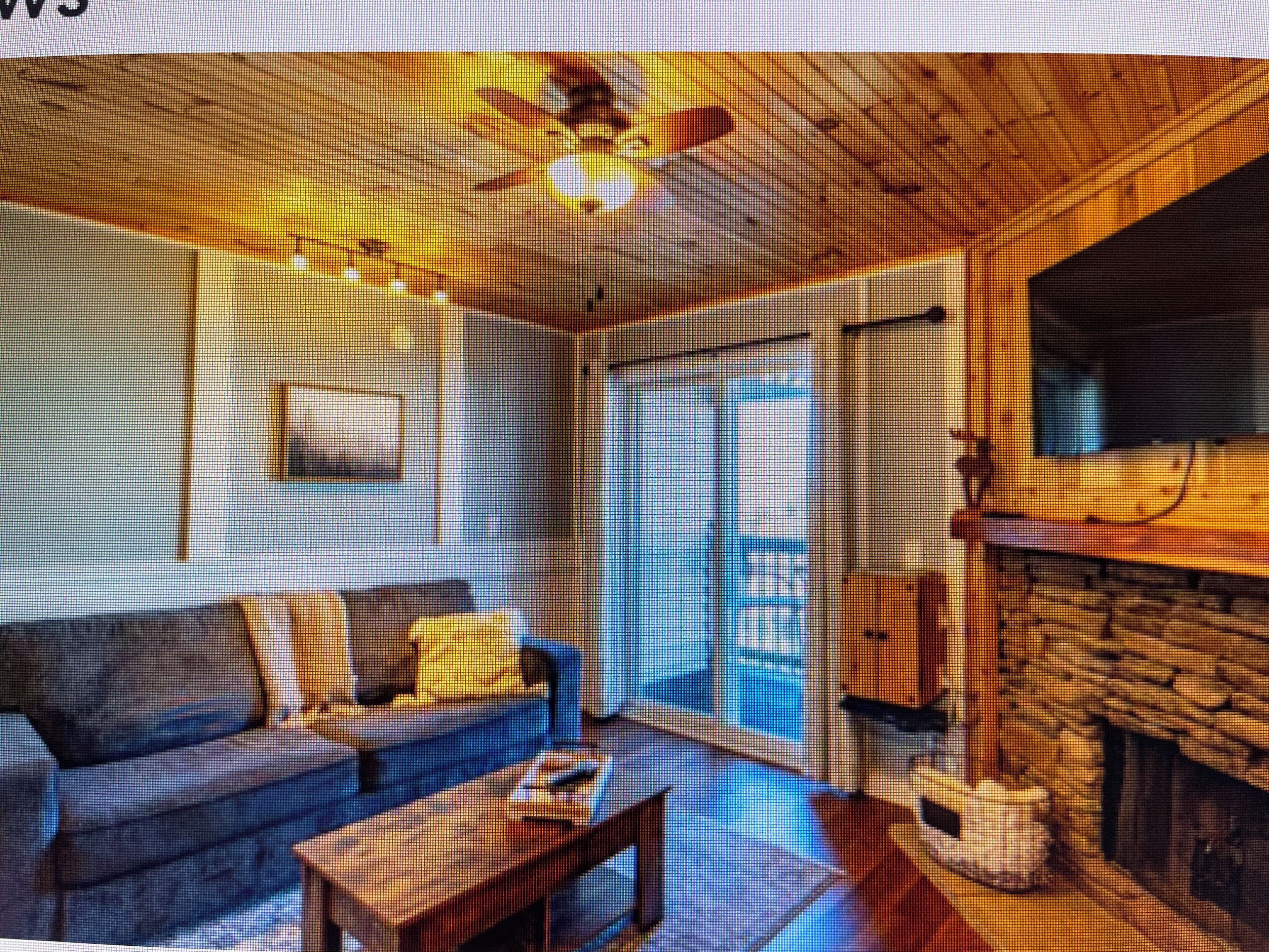 A room with a fireplace, a sofa, a coffee table, and a television.