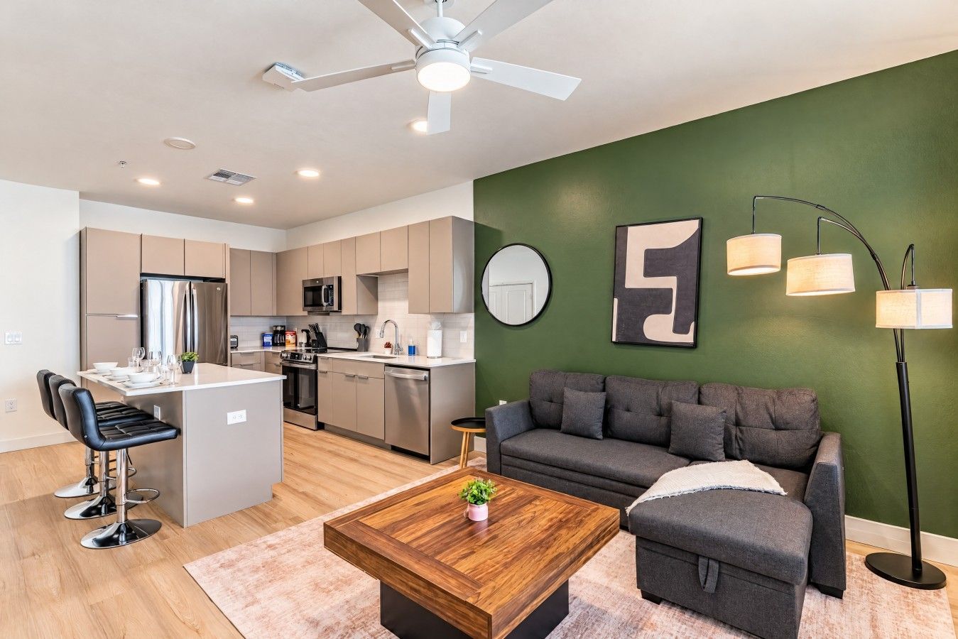 A modern apartment with a kitchen, dining area, and living room.