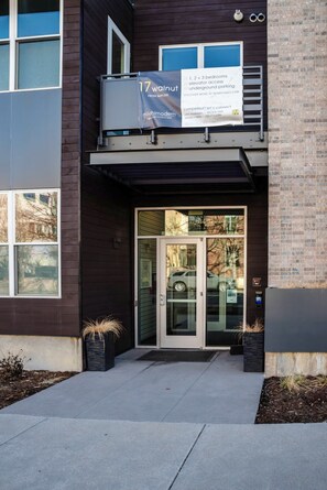 A modern building with a sign advertising 17 walnut apartments starting from $699,000. - Stunning FURNISHED 1BR/1BA Condo in Downtown Boulder - Digital Nomad's Dream (Boulder)