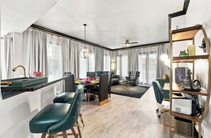 A modern living room with a dining area, a ceiling fan, and a bookshelf. - Kissimmee Family Home | 3BR, 2BA & Laundry (Kissimee)