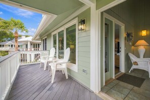 A covered porch with white chairs and a lamp. - 3 Ocean Park Court, Isle of Palms (Isle of Palms)