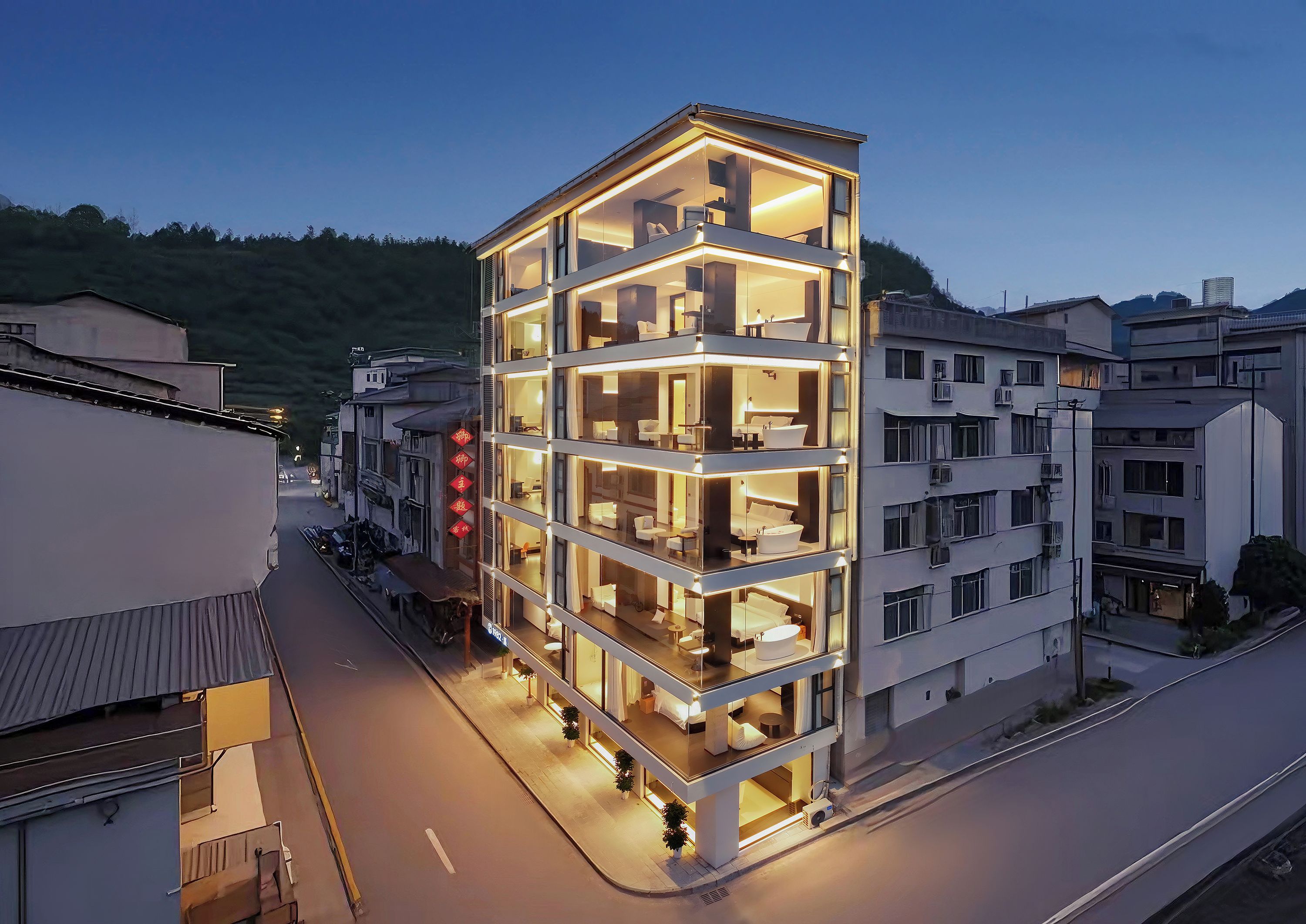 A multi-story hotel with a modern design, featuring balconies and large windows.