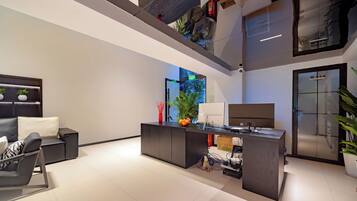 A modern reception area with a desk, seating, and a view of the outdoors.