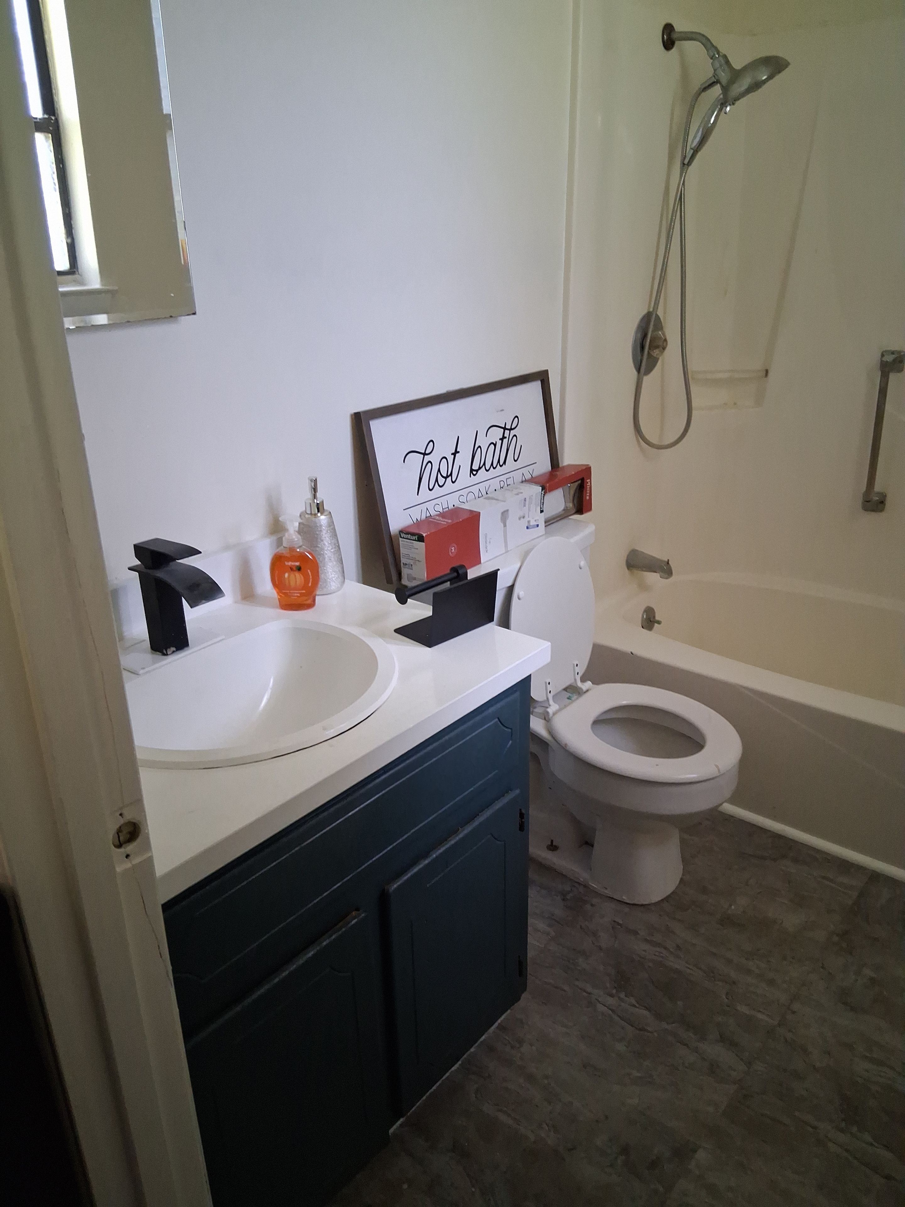 A bathroom with a white sink, a toilet, and a bathtub.