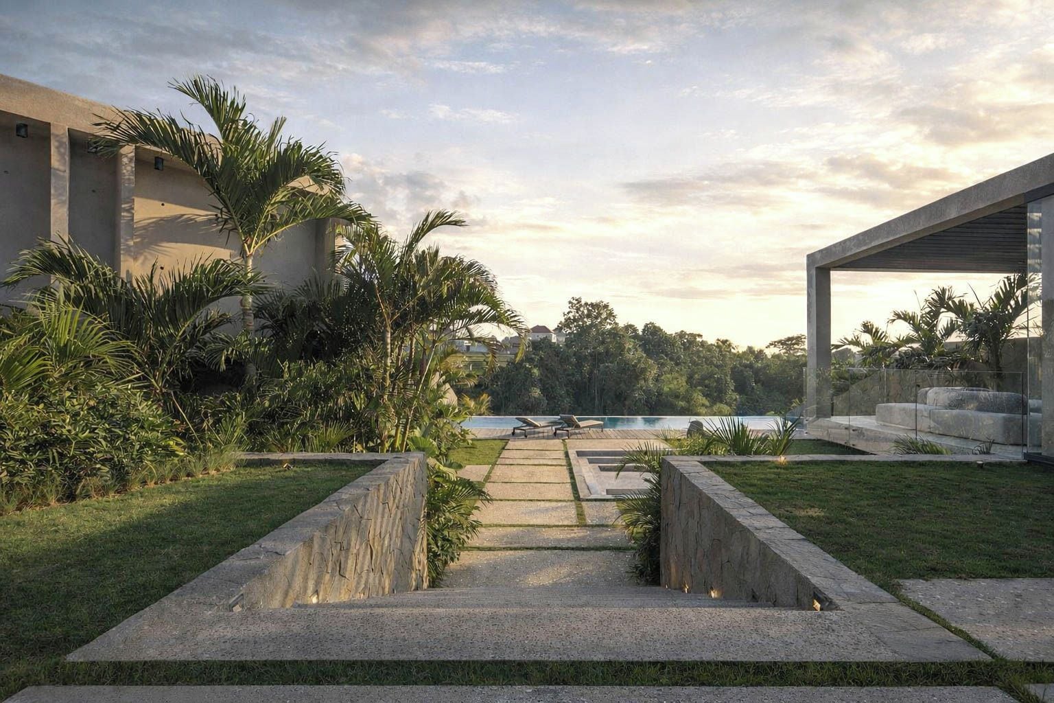 Ein Weg führt zu einem Pool mit Blick auf einen See und Bäume, umgeben von Grünflächen und moderner Architektur.